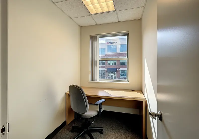Small satellite office interior with desk and window